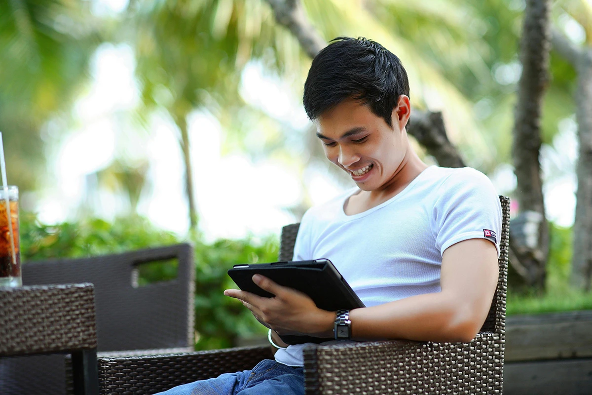 Man smiling at iPad